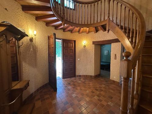 a hallway with a spiral staircase in a house at Propriété de charme avec vue panoramique in Mongauzy