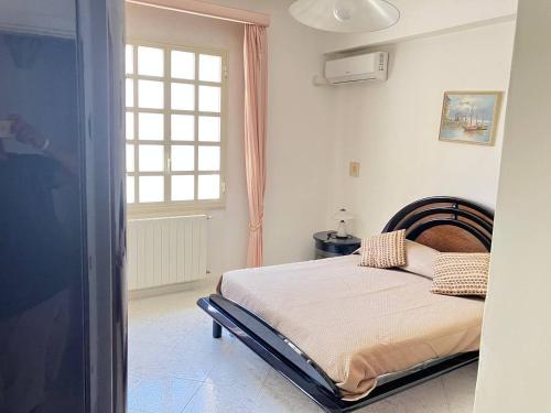 a bedroom with a bed and a window at AleMar House in Marinella di Selinunte
