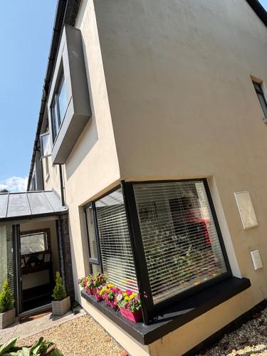 a house with a window with flowers on it at Atlas Harbour Monkstown in Monkstown