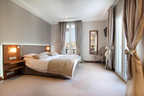 a bedroom with a bed and a large window at Le Rhul in Marseille