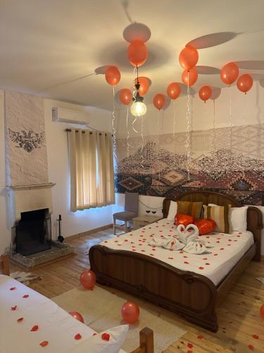 a bedroom with a bed with balloons hanging from the ceiling at VILA DISHA in Tirana