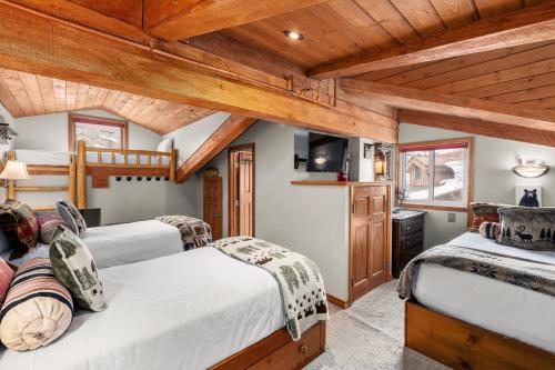 two beds in a room with wooden ceilings at Crestwood 3304 Premier 1 Bedroom Plus Loft in Snowmass Village
