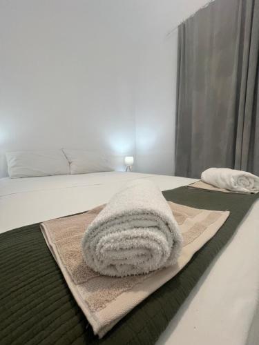 a bedroom with a bed with a towel on it at kefos apartments paros in Kóstos