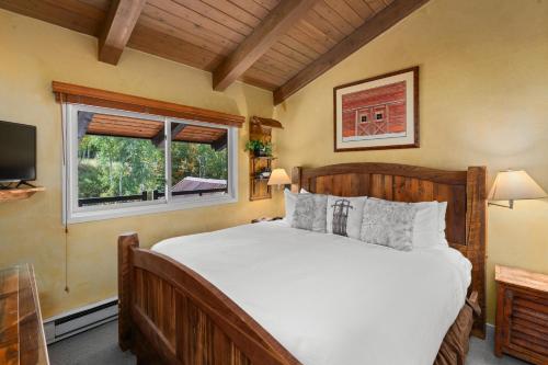a bedroom with a large bed and a window at Crestwood 3308 Deluxe 1 Bedroom Plus Loft in Snowmass Village