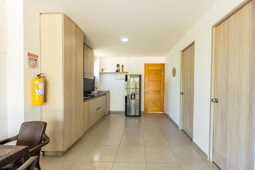 a hallway of a kitchen with a refrigerator at Dúplex de lujo con vista al mar - San Bernardo del Viento in San Bernardo del Viento