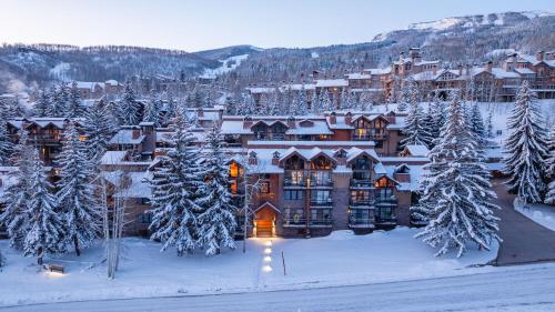 a large lodge in the snow with snow covered trees at Crestwood 3310 Standard 1 Bedroom Plus Loft in Snowmass Village