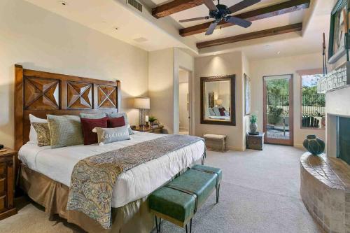 a bedroom with a large bed and a ceiling fan at Tranquility at The Rocks Club/Troon in Scottsdale