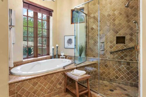 a large bathroom with a tub and a glass shower at Tranquility at The Rocks Club/Troon in Scottsdale