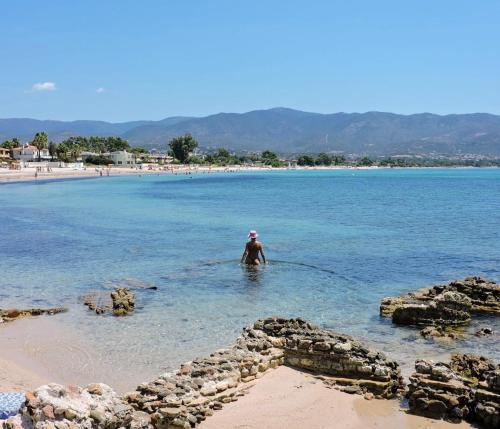 a person standing in the water at a beach at Perdas Room in Quartu Sant'Elena