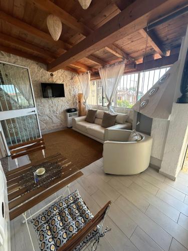 a living room with a couch and a table at Perdas Room in Quartu Sant'Elena