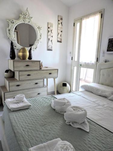 a bedroom with a bed with towels on it at Perdas Room in Quartu Sant'Elena