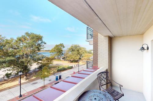 a balcony with chairs and a view of the ocean at Water Street Condos Unit 310 in Wilmington