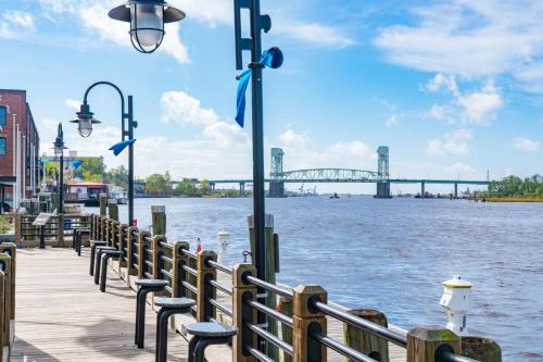a boardwalk with chairs and a view of a bridge at Water Street Condos Unit 310 in Wilmington