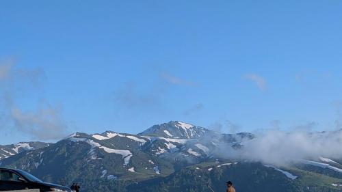 a view of a mountain with smoke coming out of it at House in forest in Gomi