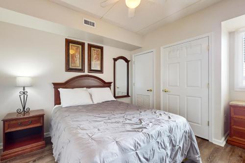a bedroom with a bed and a dresser and a window at Water Street Condos Unit 808 in Wilmington