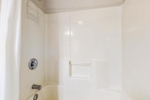 a white bathroom with a shower with a sink at Water Street Condos Unit 808 in Wilmington