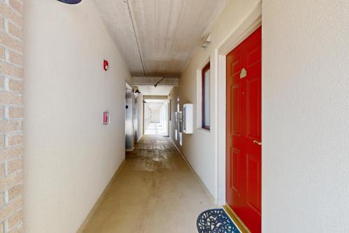an empty corridor with a red door in a room at Water Street Condos Unit 808 in Wilmington
