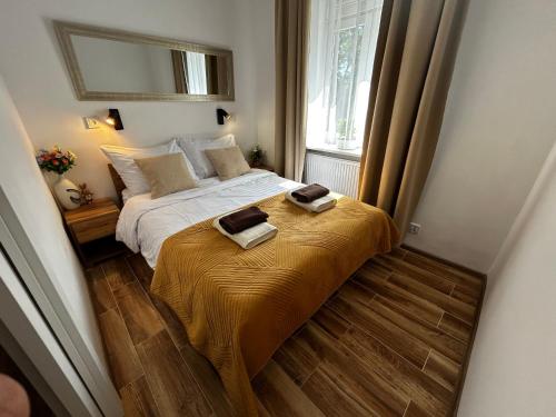 a bedroom with a bed with two towels on it at Old Cracow Apartment I in Krakow