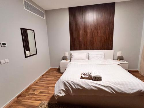 a bedroom with a large bed with a camera on it at الدرر البانورامية للعوائل فقط in King Abdullah Economic City