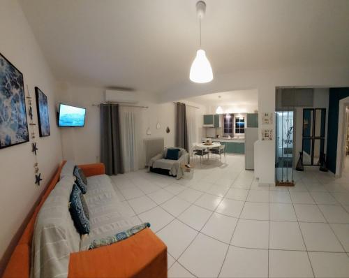 a living room with a couch and a table at Eleftheria's Apartments in Kassandria