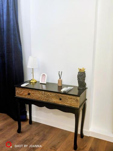 a desk with a lamp and a phone on it at Royal Lux in Sagunto