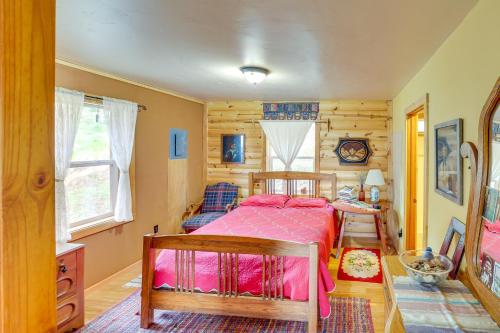 a bedroom with a bed in a room with wooden walls at Pet-Friendly Cabin on 10 Acres in Joseph Private! in Joseph