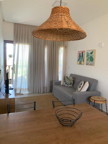 a living room with a table and a couch at Chalé I - Village da Serra in Serra de São Bento