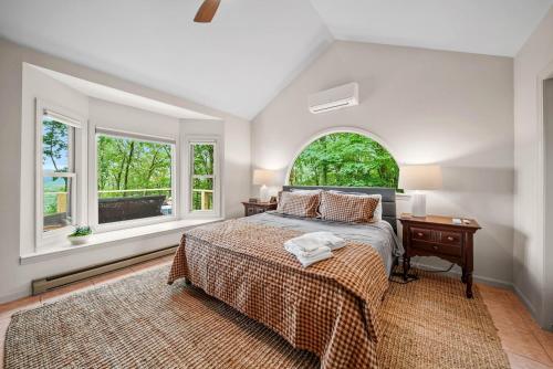 a bedroom with a bed and a desk and windows at Longview Lodge in Boone