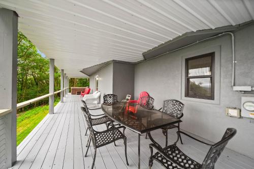 a patio with a table and chairs on a deck at Longview Lodge in Boone