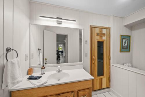 a bathroom with a sink and a large mirror at Longview Lodge in Boone