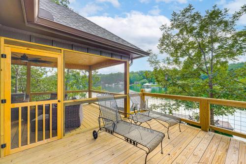 two chairs on a deck with a view of the water at Arcade Cove - Renovated Lake Martin Home with Dock in Eclectic