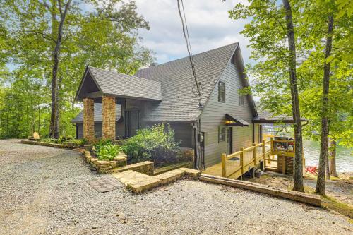 a home on the shore of a lake at Arcade Cove - Renovated Lake Martin Home with Dock in Eclectic