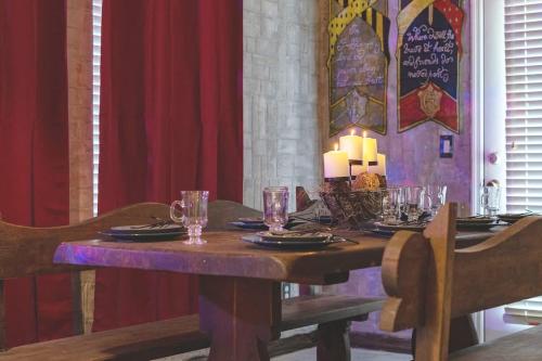 a wooden table with plates and glasses on it at Stay at Hogwarts Harry Potter's Home, Free Parking, Pets Allowed in Kissimmee