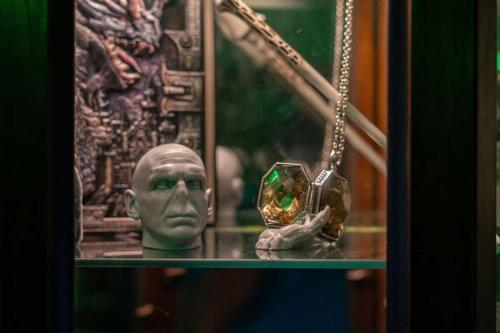 a glass shelf with a bust of a man holding a candle at Stay at Hogwarts Harry Potter's Home, Free Parking, Pets Allowed in Kissimmee