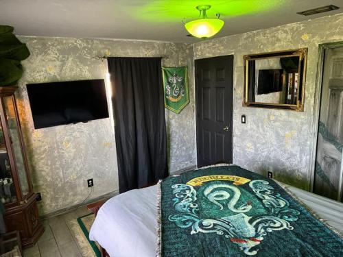a bedroom with a bed with a dragon blanket on it at Stay at Hogwarts Harry Potter's Home, Free Parking, Pets Allowed in Kissimmee