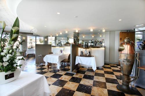 a restaurant with a checkered floor at Le Rhul in Marseille