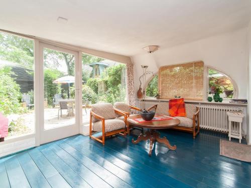 a living room with a table and chairs at Holiday Home Bergen near Forest & Beach in Bergen