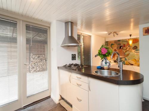 a kitchen with a sink and a counter top at Holiday Home Bergen near Forest & Beach in Bergen