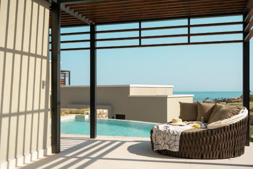 a view from the patio of a house with a pool at Mitsis Rodos Village in Kiotari