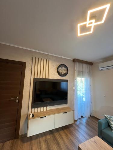 a living room with a flat screen tv on a wall at Casa Due in Novi Sad