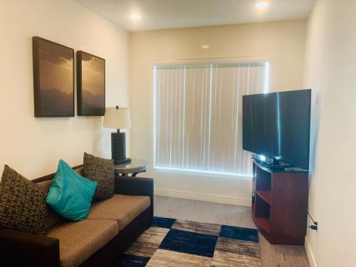 ロサンゼルスにあるUrban Chic residence in Central LAのソファと薄型テレビのあるリビングルーム