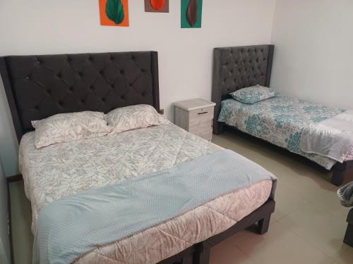 a bedroom with two beds in a room at Hostal O'Higgins in Los Andes
