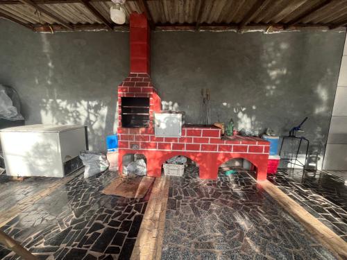 a living room with a red brick fireplace in a room at Casa com piscina para a cop 30 in Marituba