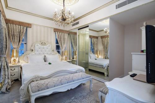 a bedroom with a white bed and a mirror at Elegance East Hotel in Antalya