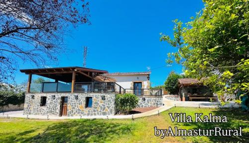 a villa kalamaja with a house in the background at VILLA KALMA by Almastur Rural 