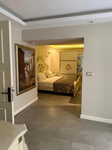 a hotel room with a bed and a mirror at Elegance East Hotel in Antalya