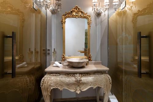 a bathroom with a sink and a mirror at Elegance East Hotel in Antalya