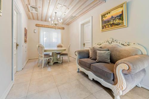 a living room with a couch and a table at Elegance East Hotel in Antalya