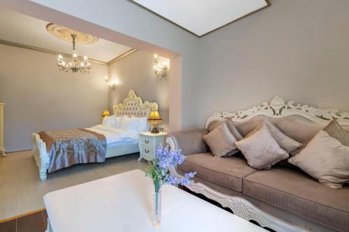 a living room with a couch and a bed at Elegance East Hotel in Antalya