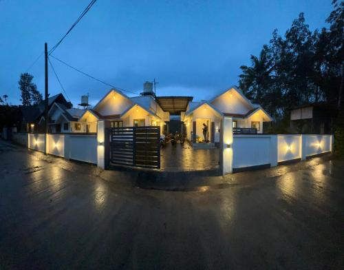 a house with lights on the side of a street at Mount Mist Villa in Munnar